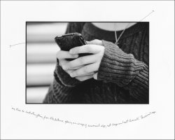 Black and white print of girl's hands using a smart phone